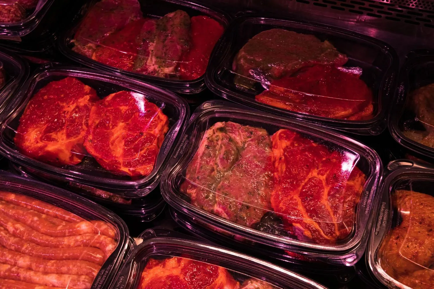 Marinated fresh meat portions in the butcher case
