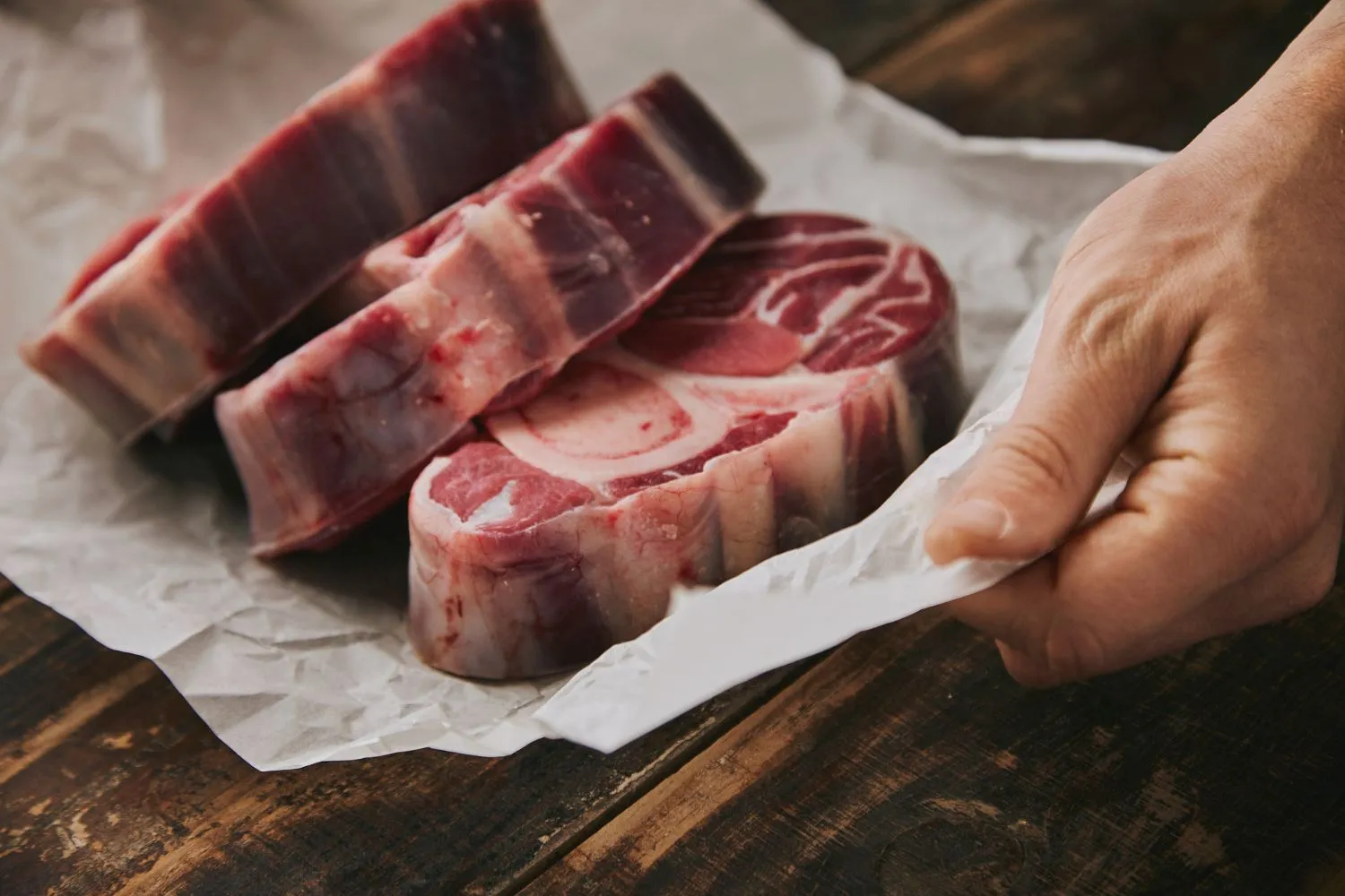 Hand-cut bone-in meat on butcher paper