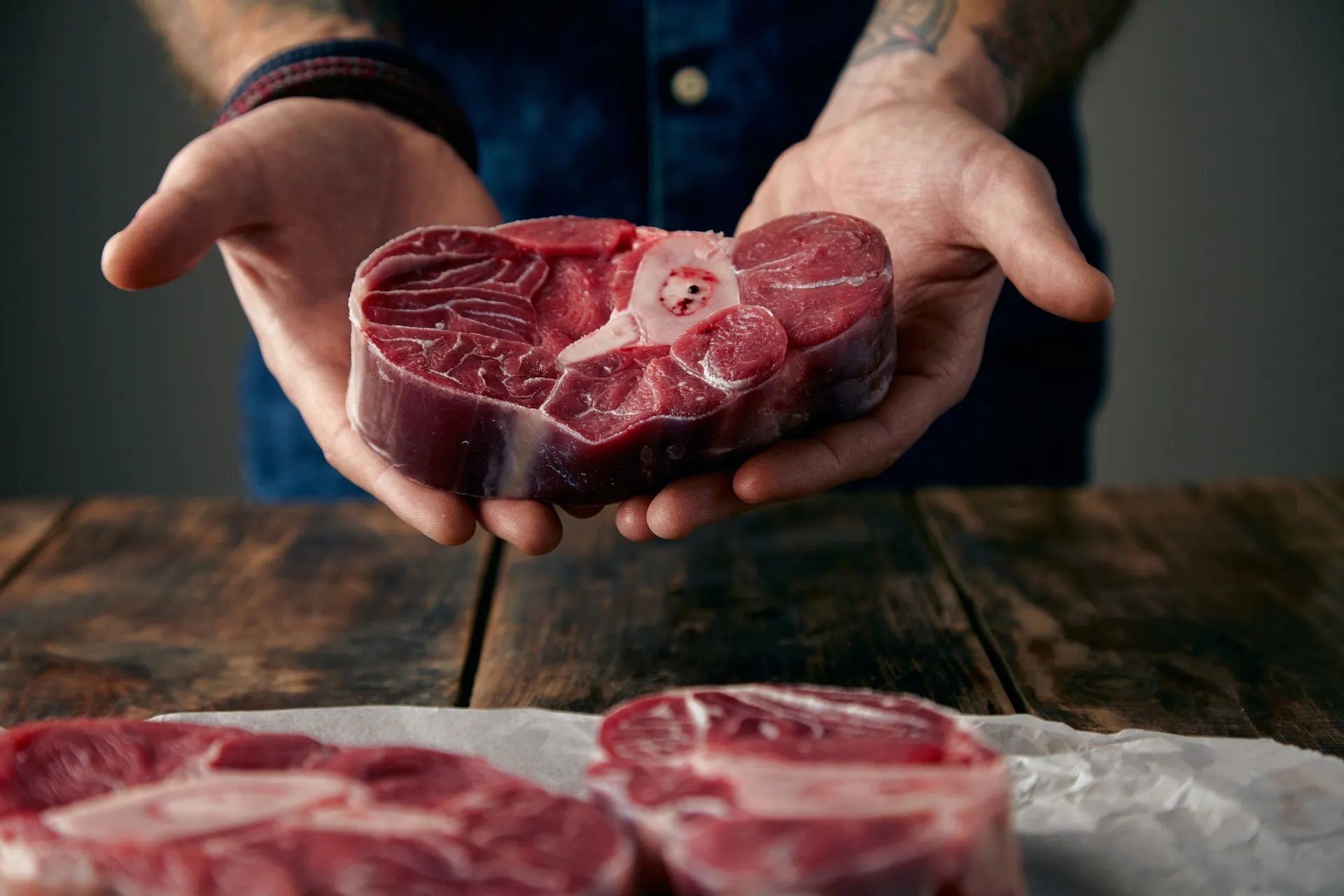 Butcher offering a fresh bone-in steak