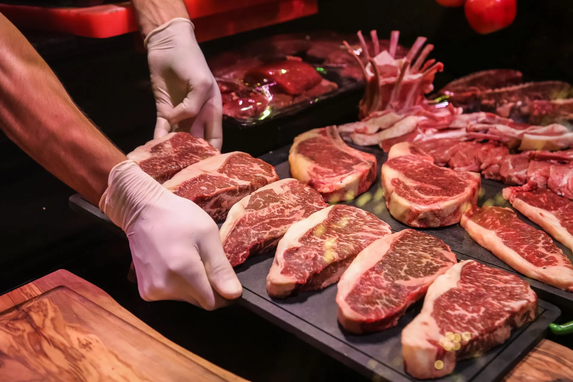 Chef preparing raw marbled beef steaks